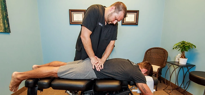 Chiropractor Wellington FL Travis Lamperski Adjusting Patient