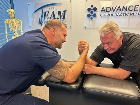 Chiropractor Wellington FL Travis Lamperski And Gregory Johnson Arm Wrestling