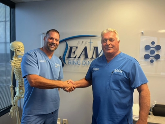 Chiropractor Wellington FL Travis Lamperski And Gregory Johnson Shaking Hands